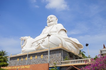 Fototapeta premium Maitreya Buddha statue located in the famous Vinh Trang pagoda in My Tho city, Tien Giang province, Vietnam.