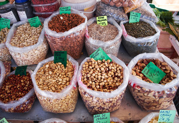 Many bags of various types of nuts for sale at Sunday market in Spain, Mercadillo de Campo de Guardamar