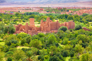 Fototapeta na wymiar Ruins of an ancient kasbah in the middle of an oasis in Dades Valley, Morocco