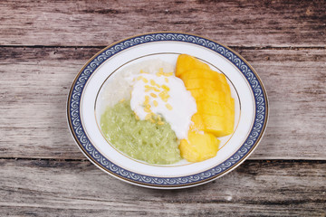 Ripe golden mango with green and white of sticky rice.