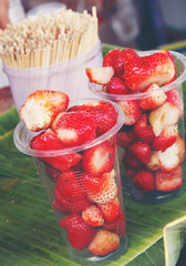  Strawberry in plastic cups ready for sale.