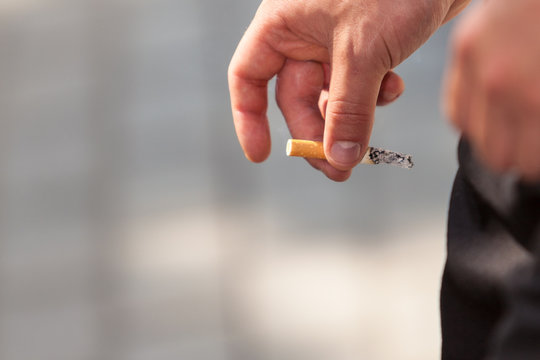 Adult Man Smoking Cigarette Outside