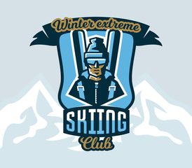 Logo skiing club. Emblem the skier in a cap and ski glasses, backpack and skis. Extreme winter sport. Isolated mountains in the background. Badges shield, lettering. Vector illustration.