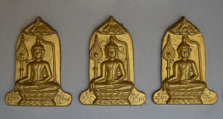 Three Buddha on Gray wall background.