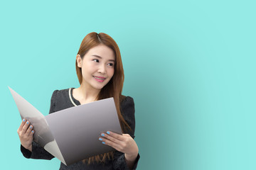 The pretty Asian business women open  the file  with the light green background