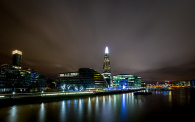 Fototapeta na wymiar Illuminated night skyline of More London and the city hall along