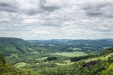 Fototapeta na wymiar Mountain background with farms, trees, plants, green vegetation