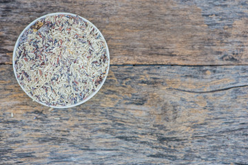 Obraz na płótnie Canvas bowl raw wholegrain rice on wooden table