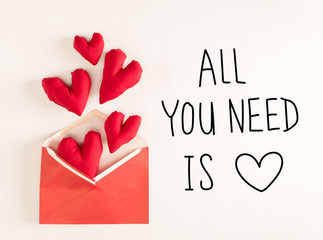 All You Need Is Love  message with red heart cushions