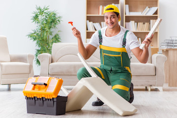 Worker repairing furniture at home