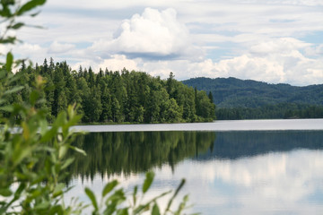 Fototapeta premium Green cape on lake. Tagasuk lake, Russia