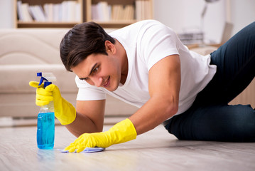 Man husband cleaning the house helping wife