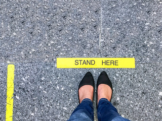 STAND HERE foot sign or symbol on the floor