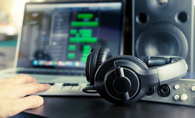 Musician is working on his home music work station