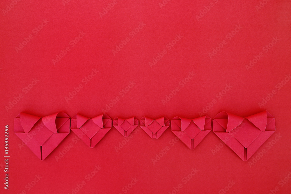 Poster six folding red paper hearts on red for valentine pattern and ba