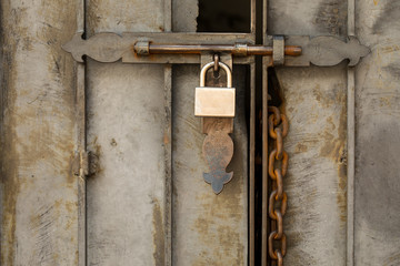 Metal Door with Brass Lock and Rusted Chain