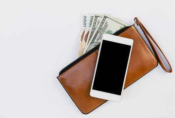 Smartphone on brown leather purse with cash money on white background