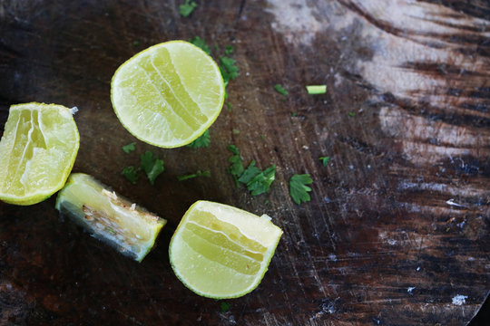 Cut into slices of lime on wooden background, empty space for your text, recipe