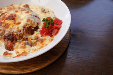 side view of baked spinach with cheese with dill and pickles in