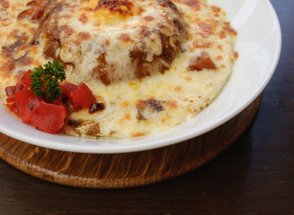 closeup baked spinach with cheese with dill and pickles in white