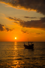 Fototapeta na wymiar Long tailed boat at sunset