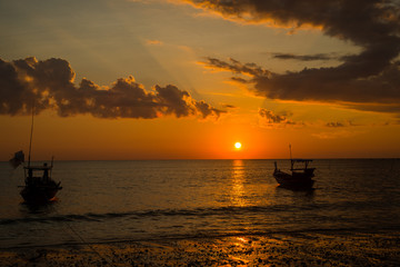 Long tailed boat at sunset