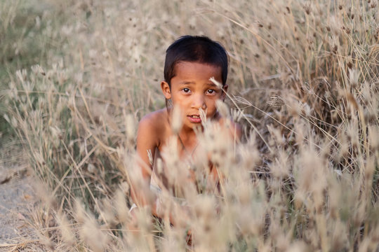 A boy thai ancient hairstyle play in farm,thailand