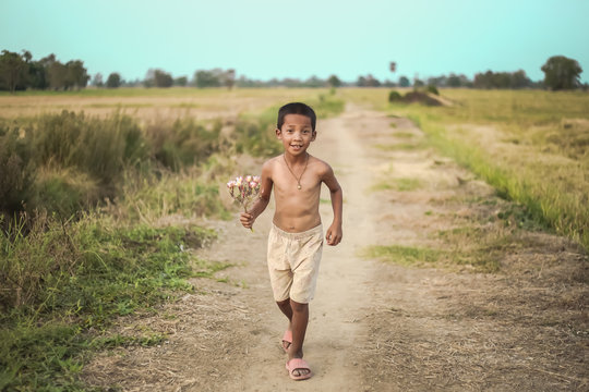A boy thai ancient hairstyle play in farm,thailand