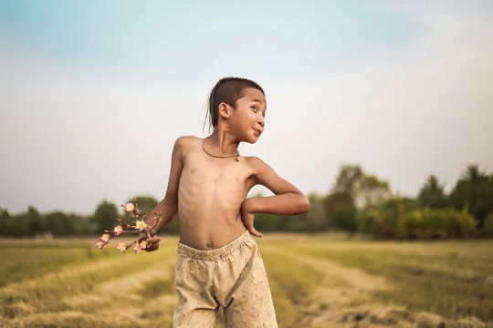A boy thai ancient hairstyle play in farm,thailand