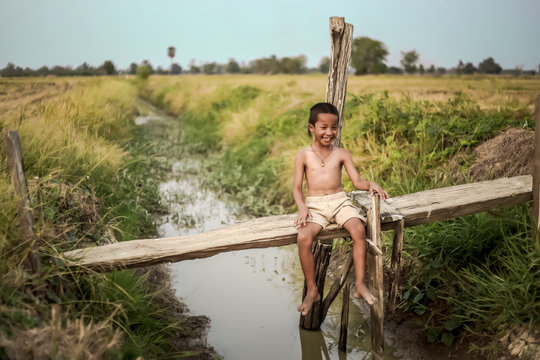 A boy thai ancient hairstyle play in farm,thailand