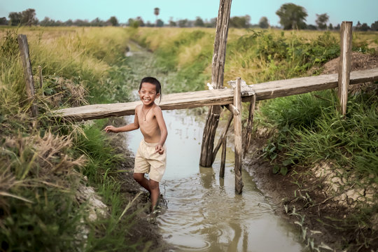 A boy thai ancient hairstyle play in farm,thailand