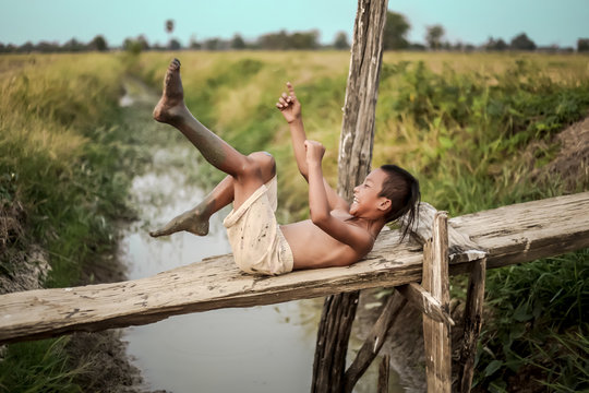 A boy thai ancient hairstyle play in farm,thailand