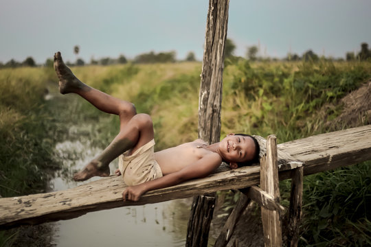 A boy thai ancient hairstyle play in farm,thailand