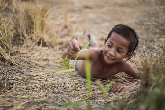 A boy thai ancient hairstyle play in farm,thailand