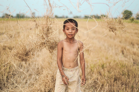 A boy thai ancient hairstyle play in farm,thailand