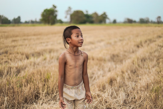 A boy thai ancient hairstyle play in farm,thailand