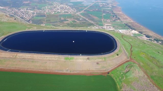 Water reservoir on top of a cliff, overlooking the sea of Galilee - Aerial footage
