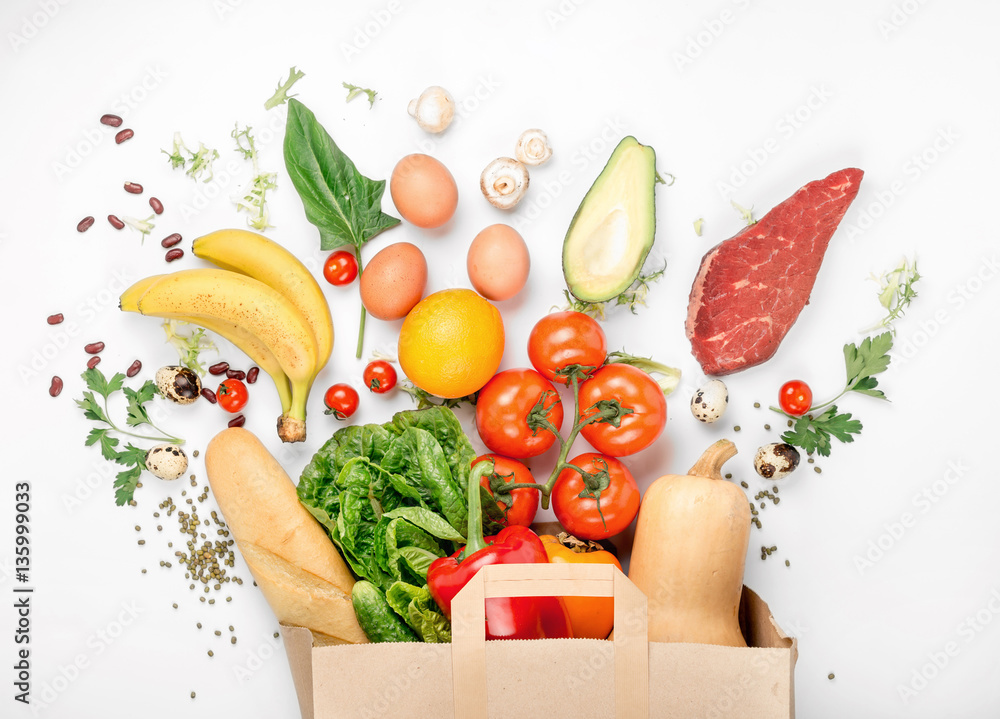 Wall mural full paper bag of different health food on white background