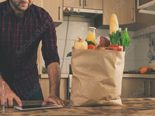 Man Holding Full Paper Bag Of Healthy Food Stock Photo And