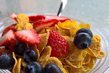 Breakfast in a Glass Bowl with Berries and Flakes
