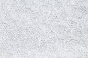 White lace with small flowers on the white background.