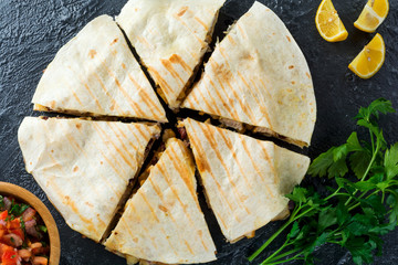 Mexican Quesadilla with chicken, corn, red beans, cheese and peppers and salsa. Selective focus.Top...