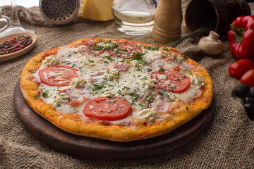 Pizza with ham cheese and tomatoes
