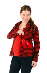 Young smiling beautiful pregnant woman holding red baby bootees,  isolated over white background