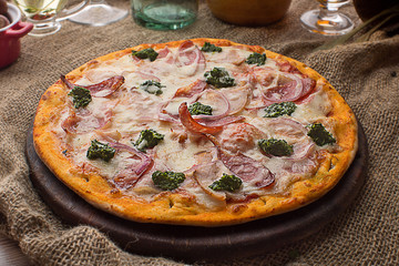 Pizza with ham cheese and spinach