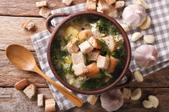 Delicious garlic soup with croutons in a bowl close-up. horizontal top view