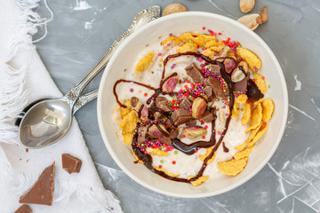 Vegan breakfast: smoothie bowl with flakes, chocolate and pistachio. Love for a healthy vegan food concept