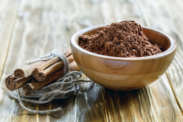 Cocoa powder in a wooden bowl.