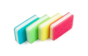Synthetic cleaning sponges different colors on a light backgroun