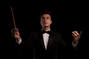 young elegant conductor directing his orchestra band